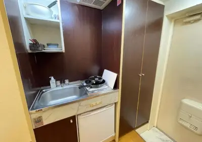 a small kitchen with a sink and a cabinet at Beverly Homes Osaki by Tranova in Tokyo