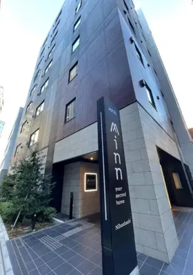 a building with a sign in front of it at Minn Nihonbashi in Tokyo