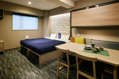 a hotel room with a bed and a table at Minn Asakusa Kappabashi in Tokyo