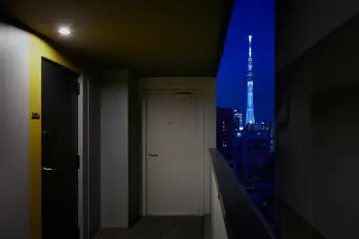 a hallway with a view of a city at night at Minn Asakusa Kappabashi in Tokyo