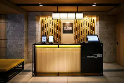 a lobby with a counter with two laptops on it at Minn Asakusa Kappabashi in Tokyo