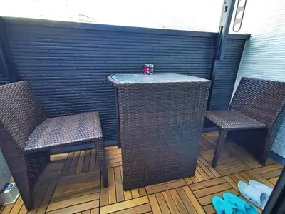 two chairs and a table with a drink on top at KIKI HOUSE \u65b0\u5c0f\u5ca9 in Tokyo