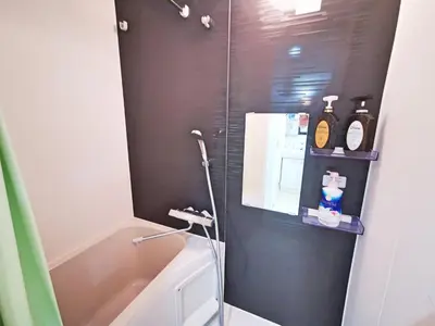 a bathroom with a shower with a toilet and a sink at KIKI HOUSE \u65b0\u5c0f\u5ca9 in Tokyo