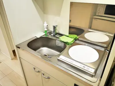 a bathroom with a sink and a mirror at KIKI HOUSE \u65b0\u5c0f\u5ca9 in Tokyo
