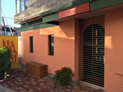 a pink building with a black door and a wooden drawer at North Cottage - Vacation STAY 09209v in Tokyo