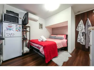 a bedroom with a bed with a red blanket at North Cottage - Vacation STAY 09209v in Tokyo