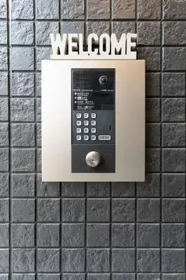 a pay phone on a tiled wall at 5963 Hotel Higashi Ikebukuro in Tokyo