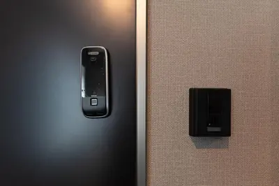 a remote control on the side of a wall at 5963 Hotel Higashi Ikebukuro in Tokyo