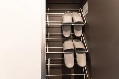 a closet with a bunch of shoes in it at 5963 Hotel Higashi Ikebukuro in Tokyo
