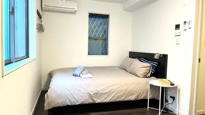 a small bedroom with a bed and a table at 5963 Hotel Higashi Ikebukuro in Tokyo