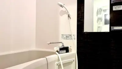 a shower in a bathroom with a bath tub at 5963 Hotel Higashi Ikebukuro in Tokyo