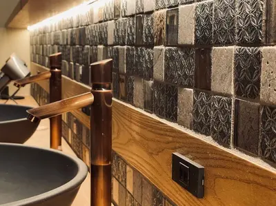 a bathroom with a sink and a counter with tiles at SPABLIC INN - Capsule Hatago Akasaka in Tokyo