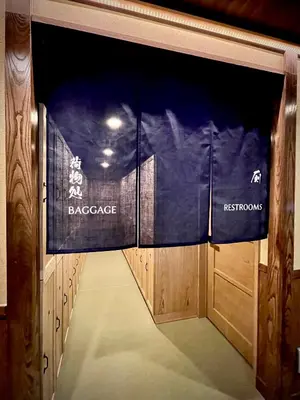 a walkway through the gate to the back cage of the dressing room at SPABLIC INN - Capsule Hatago Akasaka in Tokyo