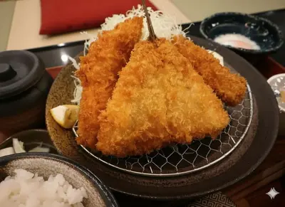 a plate of fried food on a table at SPABLIC INN - Capsule Hatago Akasaka in Tokyo