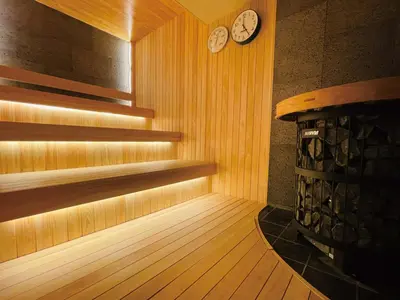 a sauna with a clock on the wall and a clock at SPABLIC INN - Capsule Hatago Akasaka in Tokyo