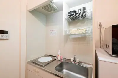 a small kitchen with a sink and a microwave at lON\u6e0b\u8c37\u672c\u753a in Tokyo