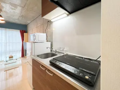 a small kitchen with a sink and a stove at lON\u6e0b\u8c37\u672c\u753a in Tokyo
