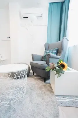a living room with a chair and a table at Shinjuku Mermaid Apartment in Tokyo
