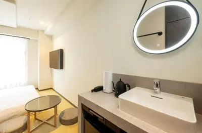 a bathroom with a sink and a mirror on the wall at HOTEL AMANEK Shinjuku Kabukicho in Tokyo