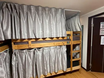 a bedroom with two bunk beds and a window at Tokyo House INN in Tokyo