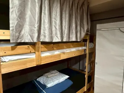an upper bunk of a bunk bed in a room at Tokyo House INN in Tokyo