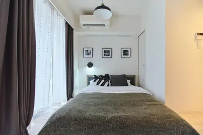 a bedroom with a bed and a large window at TORA HOTEL Sensoji \u5bc5\u30db\u30c6\u30eb \u6d45\u8349\u5bfa in Tokyo