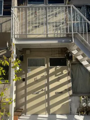 a pair of doors on a house with a staircase at \u7d4c\u5802\u306e\u5c0f\u3055\u306a\u304a\u90e8\u5c4bcottu in Tokyo