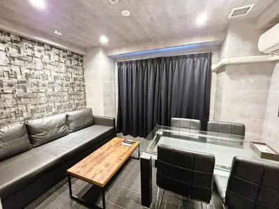 a living room with a couch and a table at SLEEPLAB THE STAY \u829d\u6d66 -Shibaura- in Tokyo
