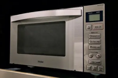 a microwave oven sitting on top of a table at SLEEPLAB THE STAY \u829d\u6d66 -Shibaura- in Tokyo