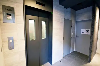 a hallway with two doors in a building at SLEEPLAB THE STAY \u829d\u6d66 -Shibaura- in Tokyo