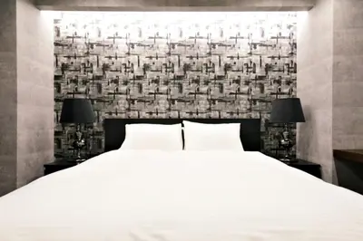 a bedroom with a white bed and two lamps at SLEEPLAB THE STAY \u829d\u6d66 -Shibaura- in Tokyo