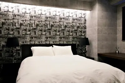 a bedroom with a large white bed and a wall at SLEEPLAB THE STAY \u829d\u6d66 -Shibaura- in Tokyo
