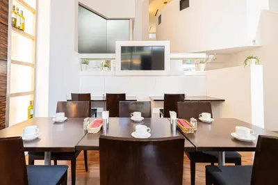 a dining room with wooden tables and chairs at Kanda Station Hotel in Tokyo