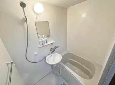 a bathroom with a sink and a shower and a mirror at SHIBUYA HOUSE in Tokyo