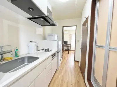 a kitchen with a sink and a refrigerator at SHIBUYA HOUSE in Tokyo