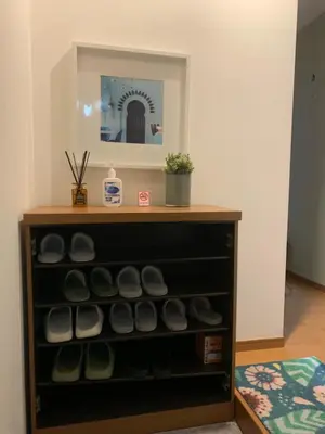a cabinet filled with lots of shoes in a room at Autumn Apartment Shinjuku in Tokyo