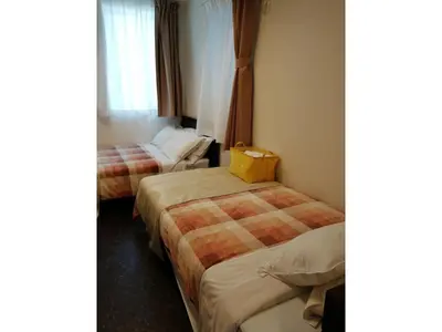 a hotel room with two beds and a yellow bag on them at Tokyo stay Hut SARI - Vacation STAY 27239v in Tokyo