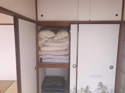 a closet with a stack of folded towels at D-pdal Inn - Vacation STAY 38493v in Tokyo