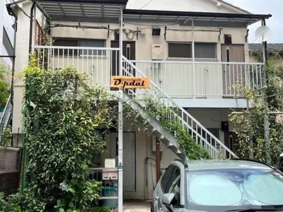 a street sign in front of a house with a balcony at D-pdal Inn - Vacation STAY 38493v in Tokyo