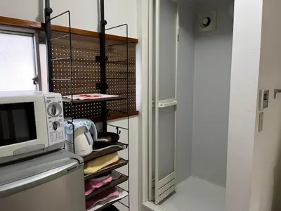 a kitchen with a closet with a microwave at D-pdal Inn - Vacation STAY 38493v in Tokyo