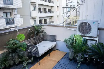 a balcony with a chair and a heater and plants at Business Hotel Kankokukan - Vacation STAY 41182v in Tokyo