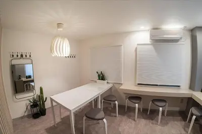 a white dining room with a white table and chairs at Business Hotel Kankokukan - Vacation STAY 41182v in Tokyo