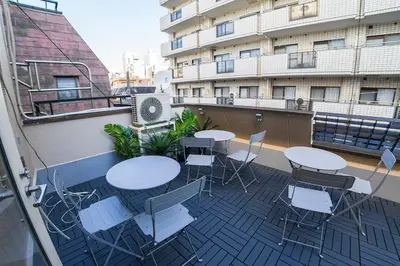 a balcony with tables and chairs on a building at Business Hotel Kankokukan - Vacation STAY 41182v in Tokyo