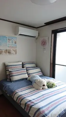 a bed with a teddy bear sitting on top of it at City Pal 