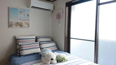 a teddy bear sitting on a bed in a bedroom at City Pal 