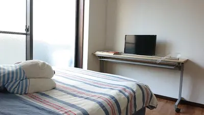 a bedroom with a bed and a television on a table at City Pal 