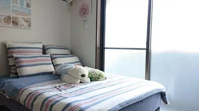 a teddy bear sitting on a bed in a room at City Pal 