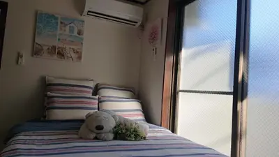 a teddy bear sitting on top of a bed at City Pal 