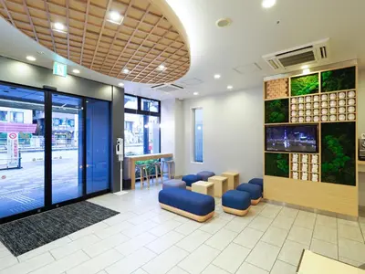 a waiting room with blue chairs in a building at Far East Village Hotel Tokyo, Asakusa in Tokyo