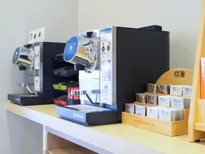 a coffee machine sitting on a counter with books at Far East Village Hotel Tokyo, Asakusa in Tokyo